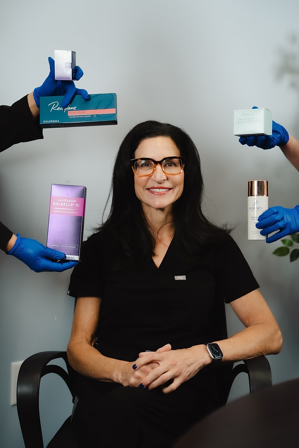 Woman surrounded by skincare products and treatments.