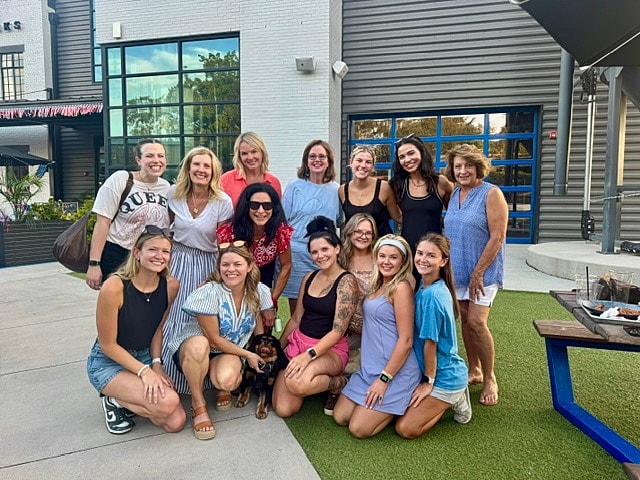 Group of women posing together outdoors.