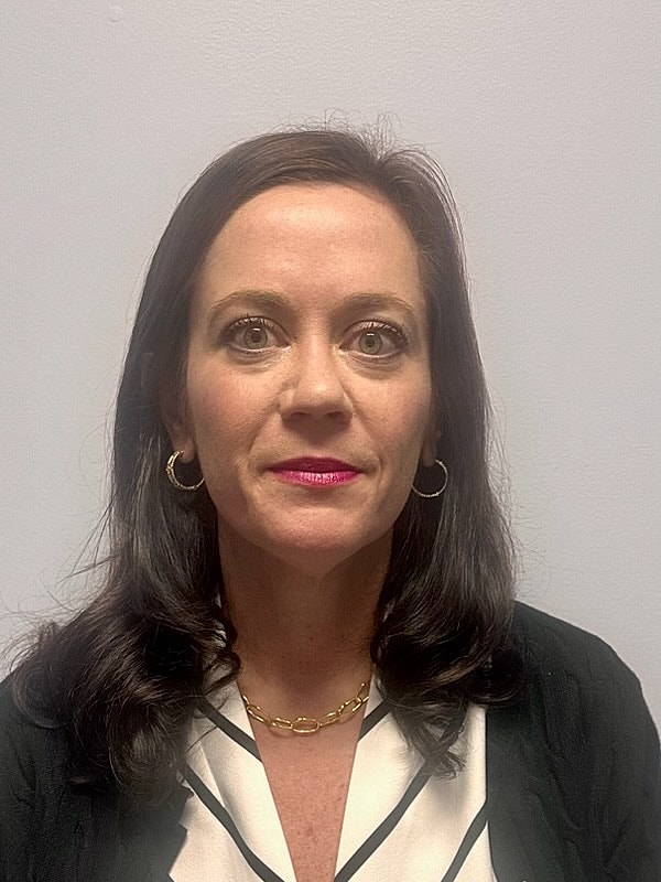 Woman with long hair, earrings, and pink lipstick.