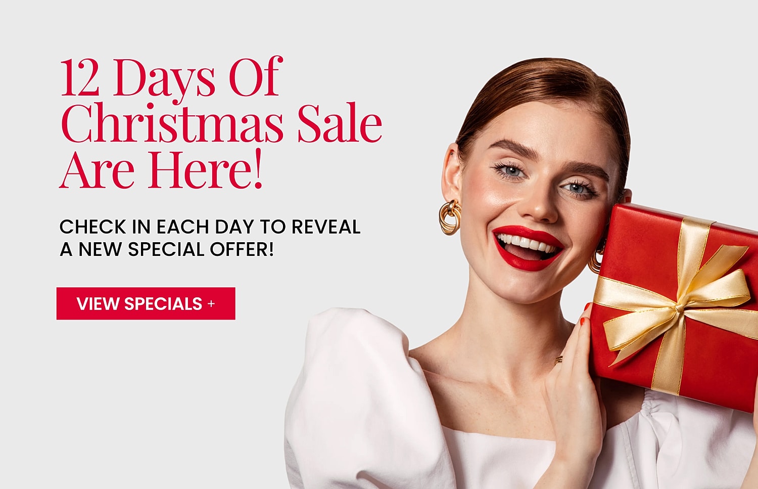 Christmas sale promotion with smiling woman and gift.